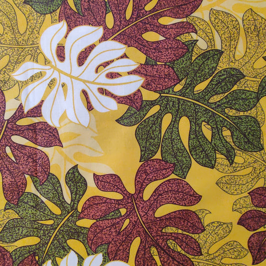 zomm sur tissu tahitien en coton feuilles de monstera marron et vertes sur fond jaune soleil