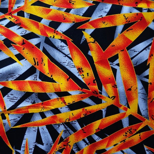 Détail motif Feuillages tropicaux stylisés dégradé orange rouge jaune gris sur fond noir 100% coton