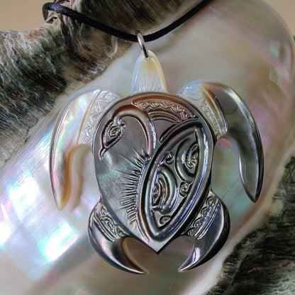 Pendentif Honu tortue polynésienne, en nacre gravée de Tahiti. Bijou polynésien artisanal aux reflets naturels irisés