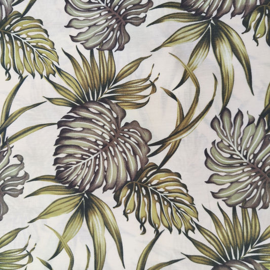 Détail motif Monstera et feuillages tropicaux vert sauge sur fond écru naturel 100% coton