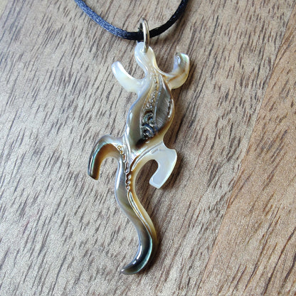 Pendentif geckko margouillat en nacre gravée de Tahiti. Bijou polynésien artisanal monté sur lien noir ajustable.