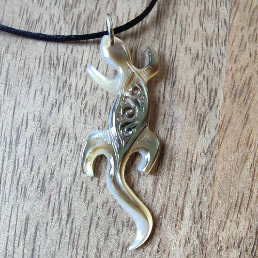Pendentif geckko margouillat en nacre gravée de Tahiti. Bijou polynésien artisanal monté sur lien noir ajustable.