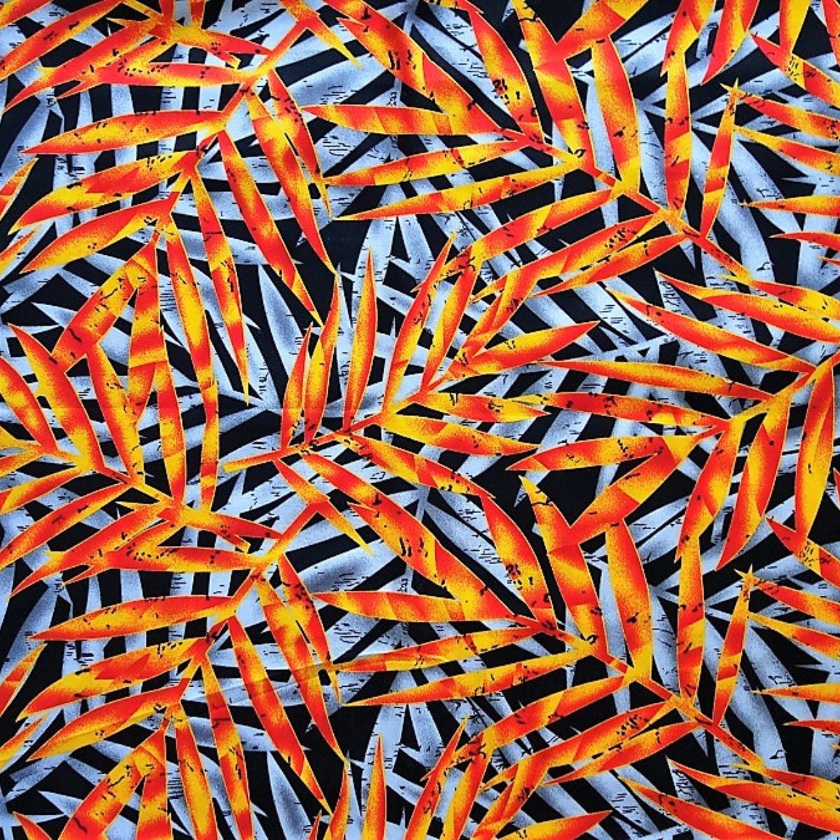 Tissu coton Feuillages polynésiens orange jaune rouge fond noir motifs tropicaux Couleurs du Fénua