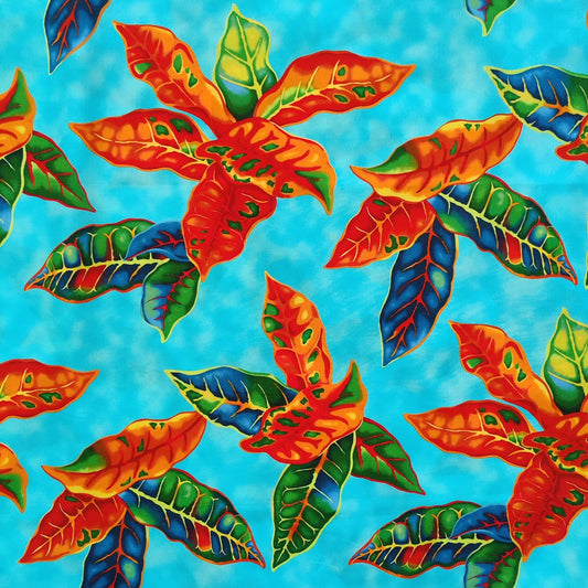 Tissu tahitien en coton, détails des motifs crotons orange et vert sur fond bleu turquoise. Tissu exclusif - dernier coupon.