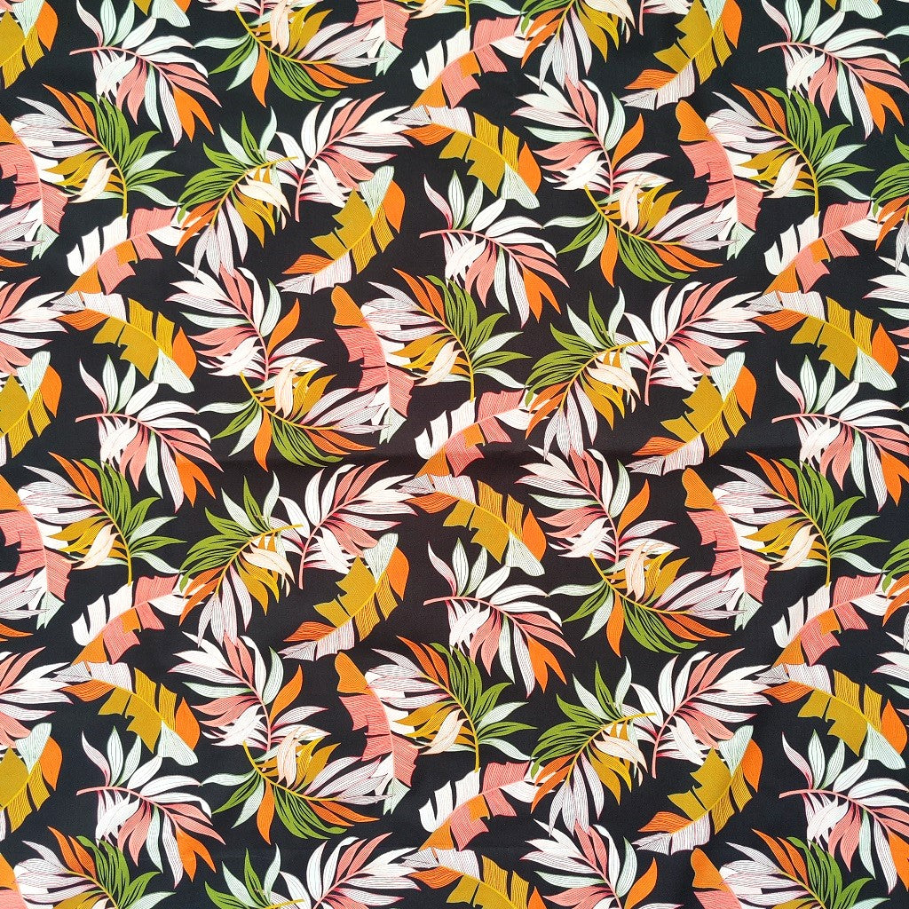 Tissu tahitien en coton, motifs feuilles de bananiers et fougères sur fond noir intense. Edition limitée - aucun réassort.