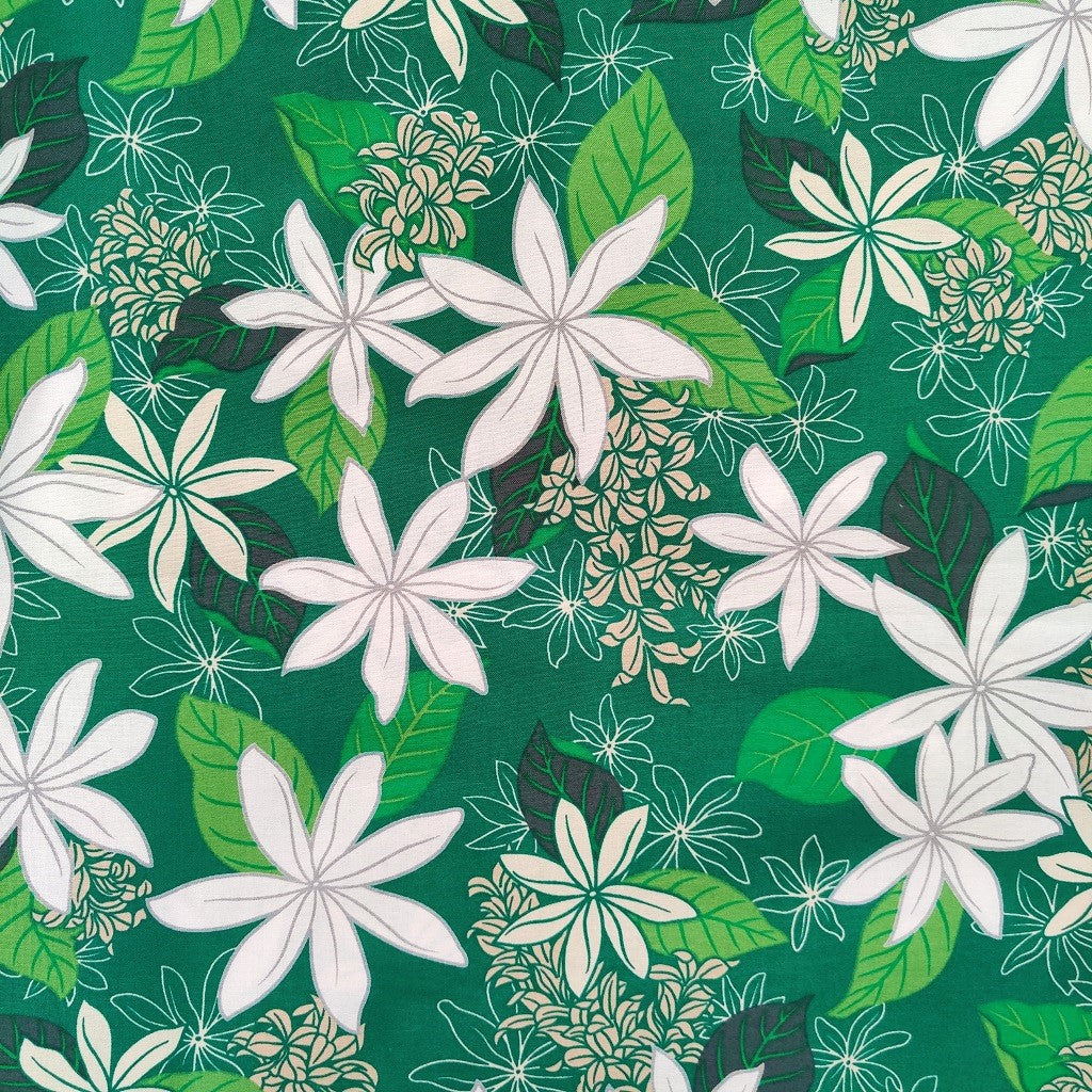 Tissu tahitien en coton, détails des motifs fleurs de tiarés blanches sur fond vert lumineux. Aucun réassort, dernier métrage.