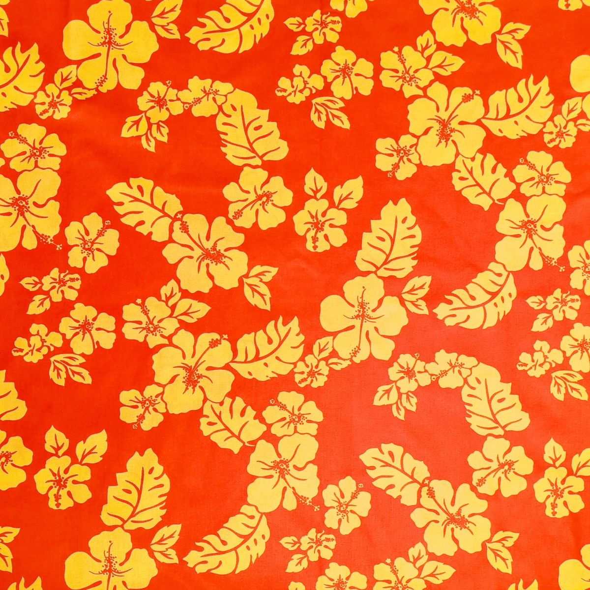 Tissu tahitien en coton, motifs hibiscus et feuillage jaune sur fond orange lumineux. Motifs tropicaux polynésiens aux couleurs du Fénua