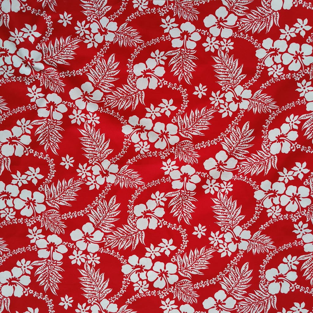 Tissu tahitien en coton, motifs hibiscus, fougères et tiarés blanches sur fond rouge vif. Edition limitée, dernier coupon.